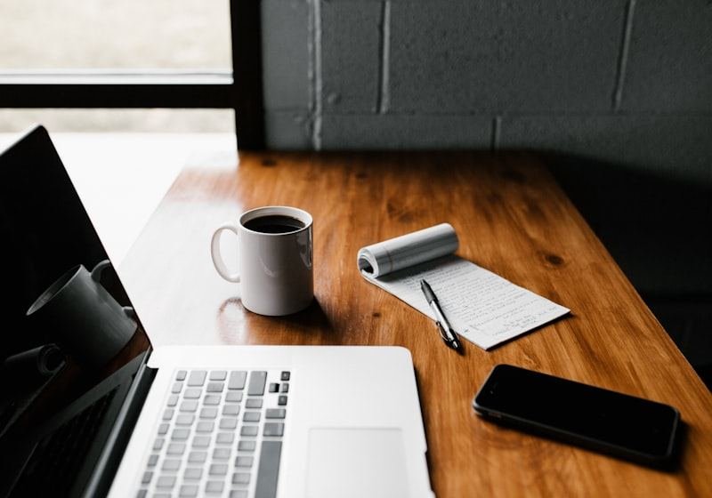 Writer planning a content strategy at a laptop with coffee