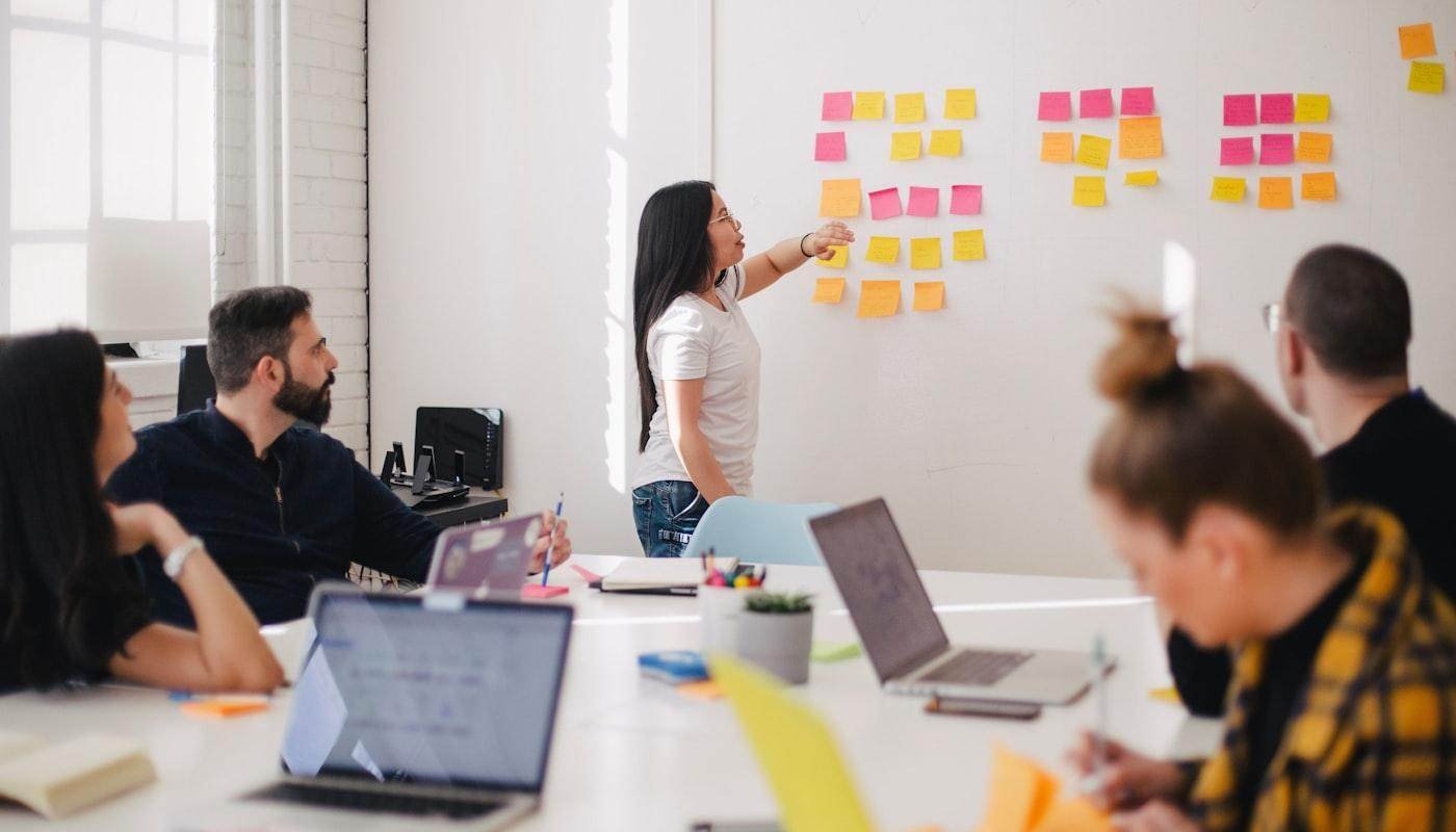 POSTPEAK growth team planning a marketing campaign around a strategy board